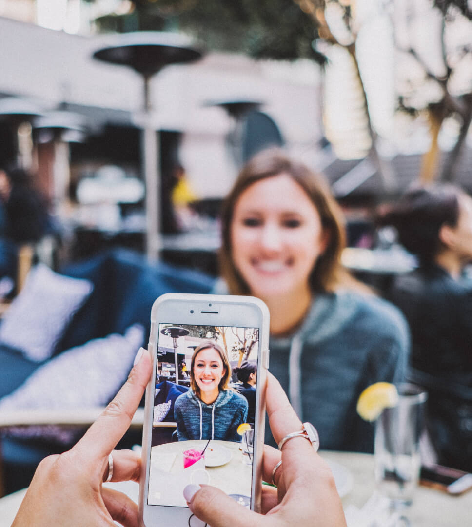Taking photo of woman at lunch